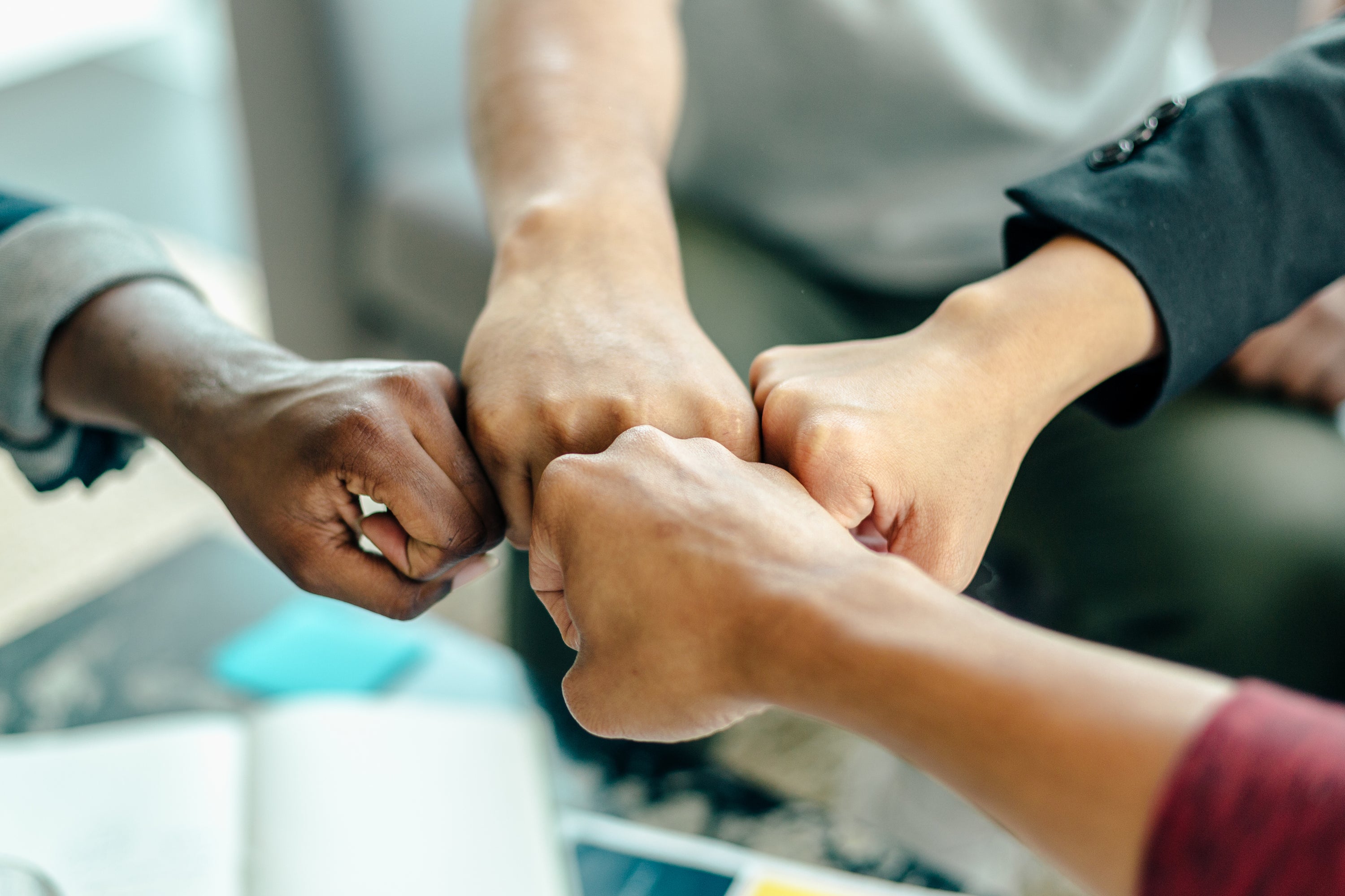 Four way fist bump at work.